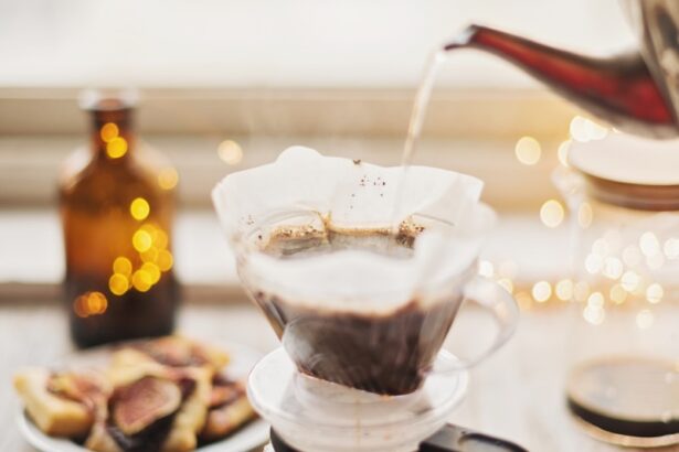 hot water from pot being poured into coffee carafe on table